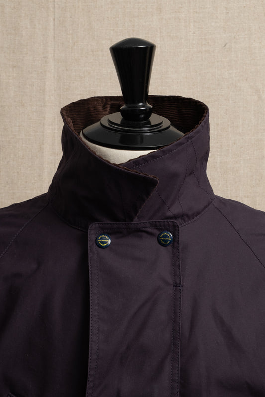 Dark blue coat on a mannequin against a beige textured background