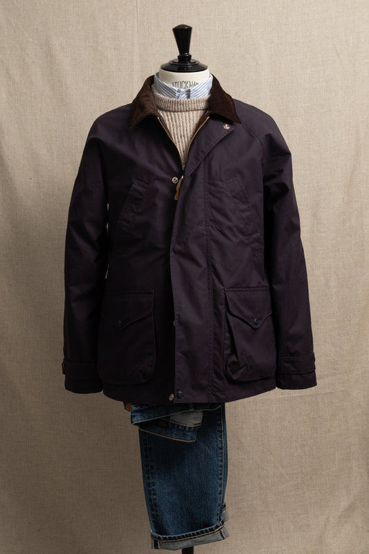 Dark jacket on a mannequin with a plain background